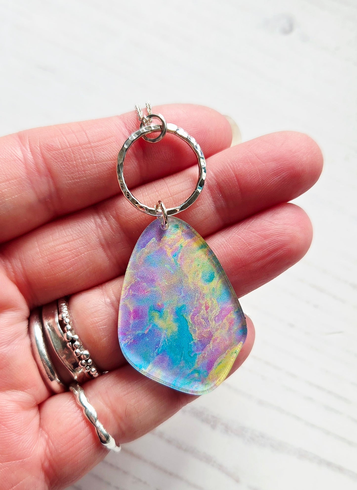 Pebble pendant with hammered silver hoop, Opal print