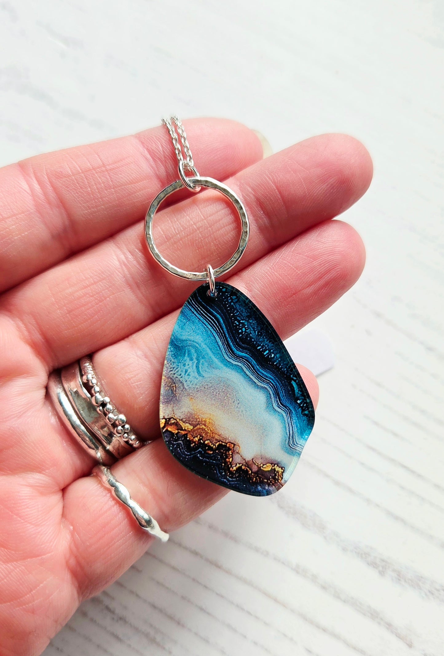 Pebble pendant with hammered hoop, blue swirl print