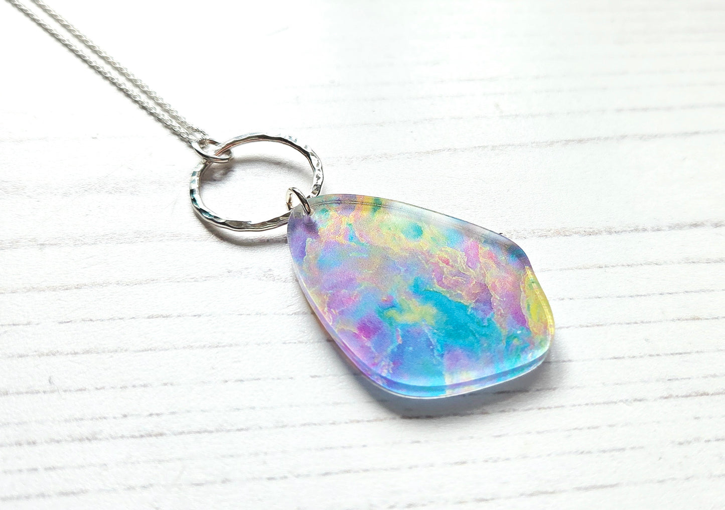 Pebble pendant with hammered silver hoop, Opal print